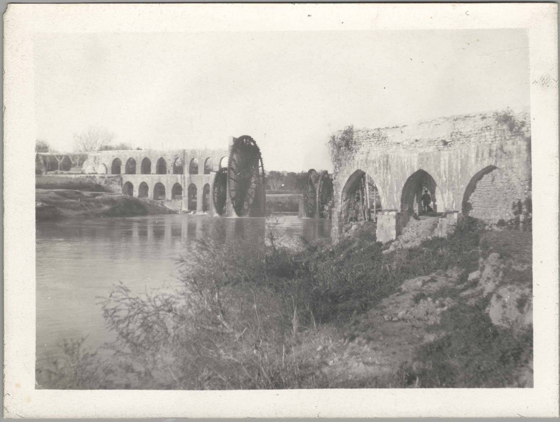 Dick view of water wheels and aquaduct along the Orontes River